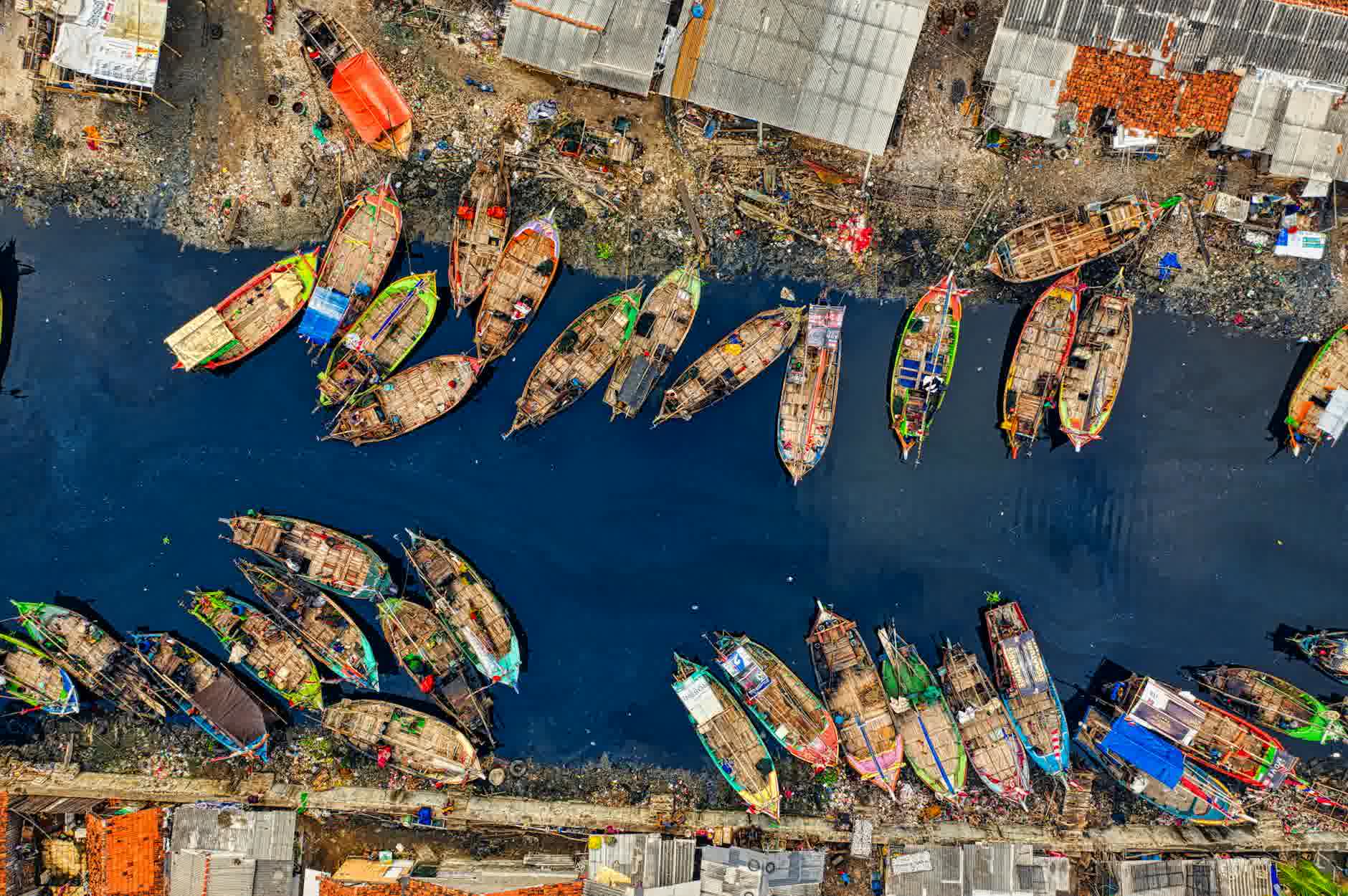 aerial view of fishing boats docked along the river